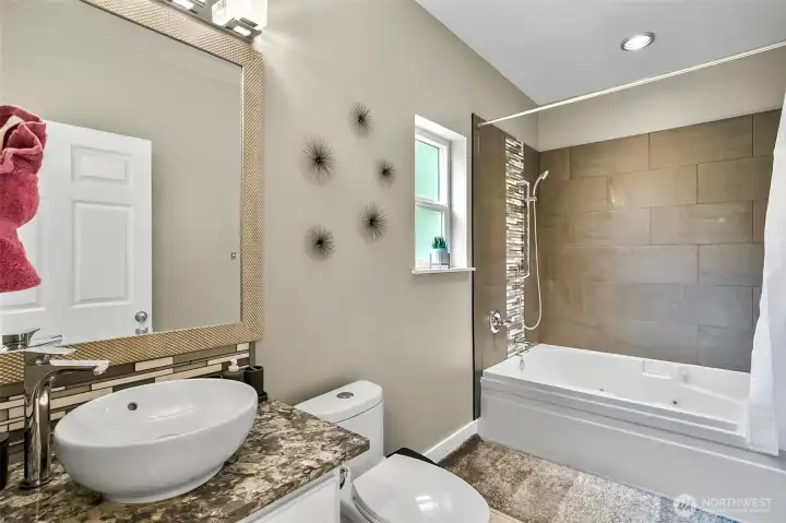 Main floor full bathroom with spa inspired jetted soaking tub Main floor full bathroom with spa inspired jetted soaking tub