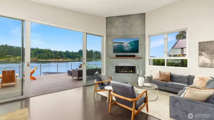 Back inside the living room looking southwest. The massive doors and many windows make the home expansive.