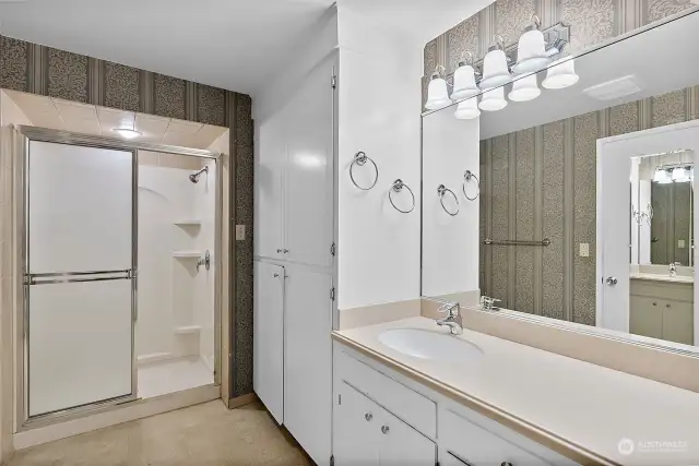 On suite bathroom is a full size shower, solid wood cabinetry, lots of storage space