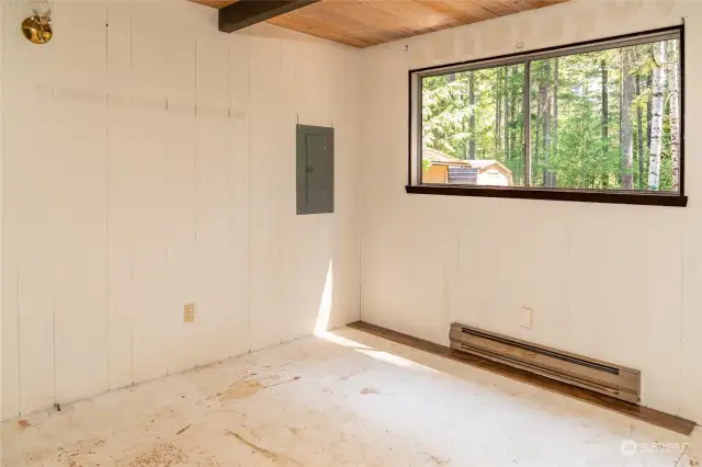 Main level bedroom. Seller will leave new flooring (currently stored under loft stairs)