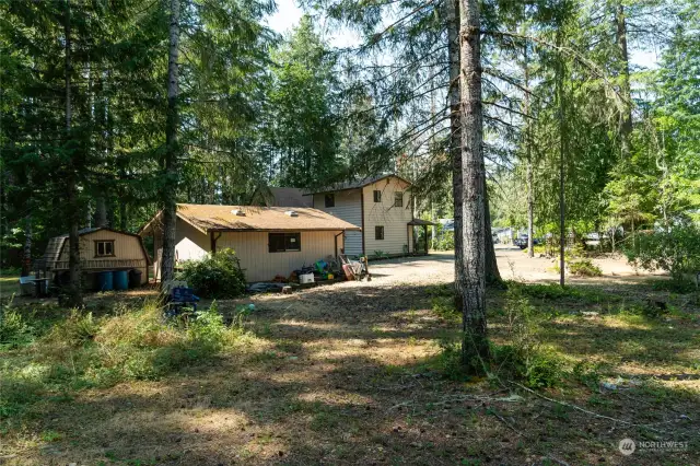 View of home, garage & storage shed from second lot.