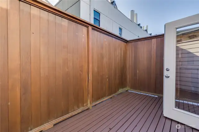 Spacious deck off the den/office with high privacy fence