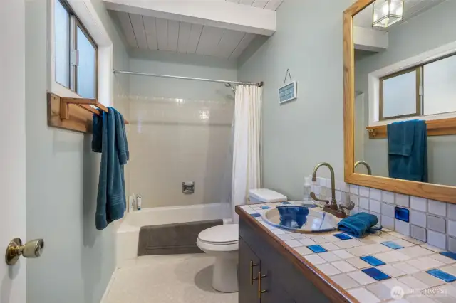 Main floor full beathroom with tub, shower head and heater.