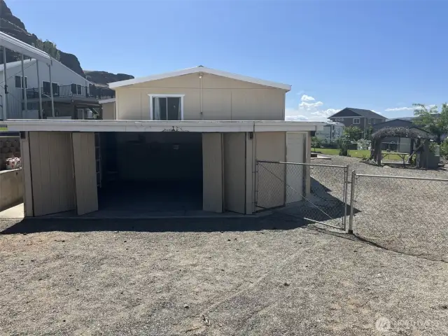 View of the house with the garage doors open.