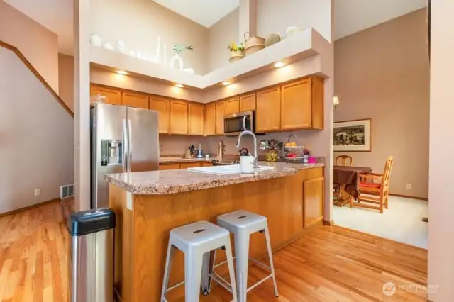 Kitchen includes a breakfast bar and is located in the center of the home.