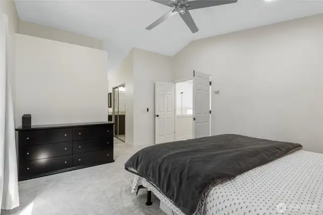 Primary bedroom with vaulted ceilings