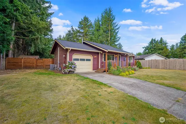 Attached garage and paved driveway.