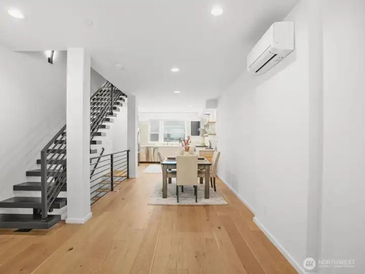 Beautiful, bright dining & kitchen with floating staircase.