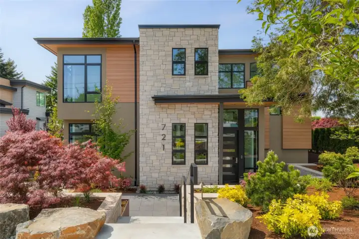 Front elevation draped in luxury finishes. Full height true stone, stucco, and luxury state of the art composite (no maintenance) siding creates a perfect mixture of textures