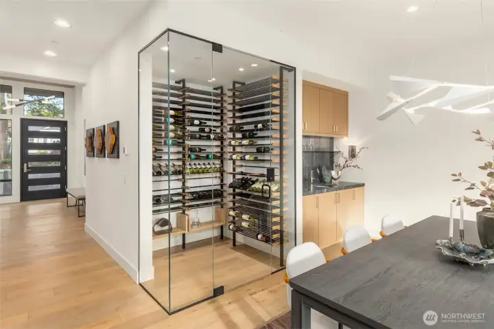 Statement temperature controlled wine room with frameless glass surround