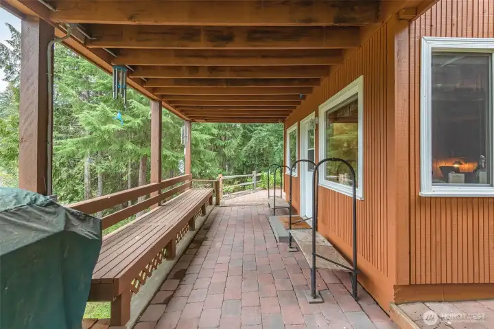This generous covered patio is wonderful for entertaining all year long, and easily accessible after snowmobiling. The door enters the lower level family room which features the snowmobiling mud room.