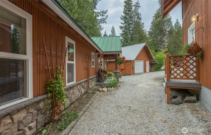 The side door on the detached 2-story garage is only a few steps from your front entry (workshop shown in the distance)