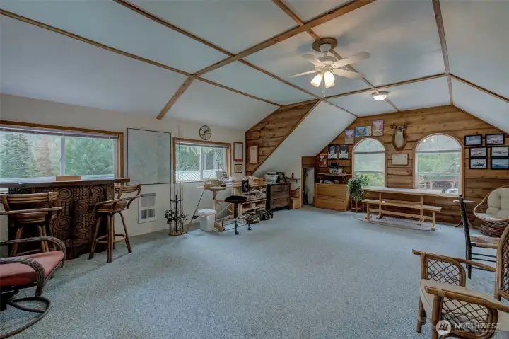 Finished loft above the garage is heated, surrounded by view windows and offers lit-up under-eave storage for your holiday decorations and keepsakes (not shown)
