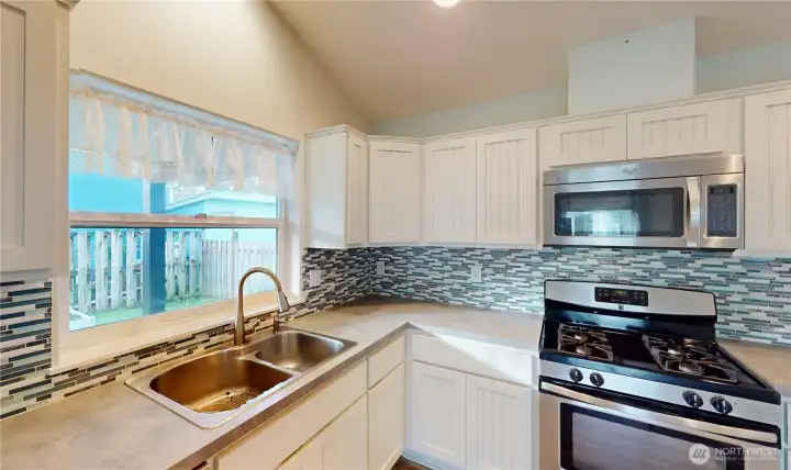 Kitchen sink over looks the side yard.