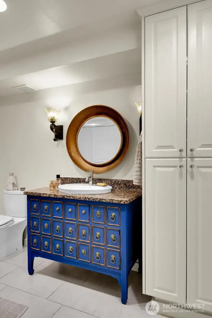 Check out the cool custom vanity in the full bath—stylish and super functional with great storage!