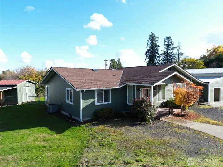 Front view of home, attached garage and garden shed/coop in back.