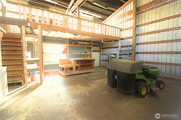 inside of shop with stairs and mezzanine, door to side