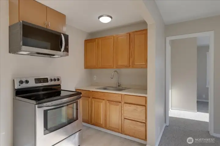 Unit #1 New flooring in kitchen and bath. Fresh paint, carpet moldings, light fixtures, microwave, toilet, bath vanity and more!