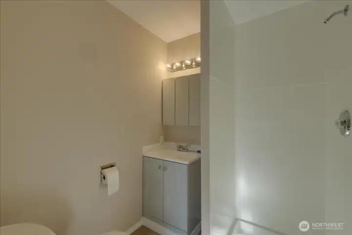 Unit #1 Here's the new vanity, mirror, toilet and water proof vinyl plank flooring.