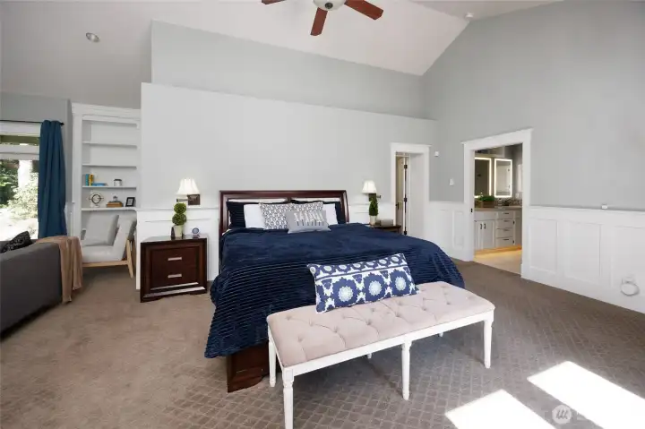 Enormous primary suite features French doors with deck access to the swim spa.