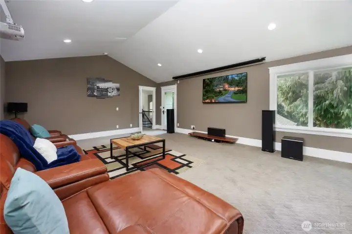Recreation room with vaulted ceilings & door to the yard.