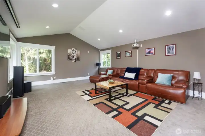 Oversized recreation/theater room with a walk-out back yard.