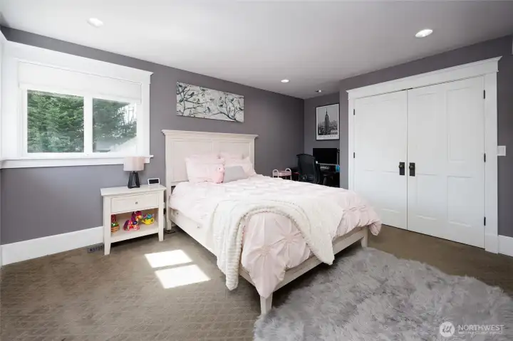 Corner bedroom with a remodeled en-suite bathroom.