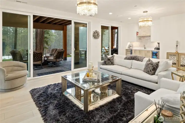 Lower level spacious recreation room with wet bar & GE dishwasher and second gas fireplace opens to an outdoor oasis: covered patio, hot tub, gas fire table and 36" fire pit.