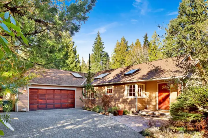 Welcome Home! Tucked into a tree lined driveway provides privacy from the road, with aggregate driveway and flagstone patio entry. Two car oversized garage. Beautifully landscaped property. Home faces East to get morning sunlight.