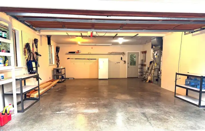 Oversized attached two car garage with door into the family room and separate door to the back yard.