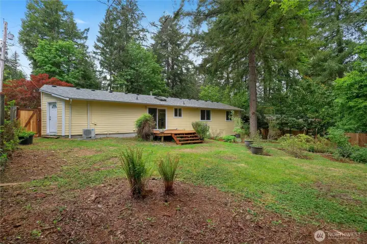 Nearly 1/4 acre lot with deck, lawn area, mature landscaping, and great backyard privacy.