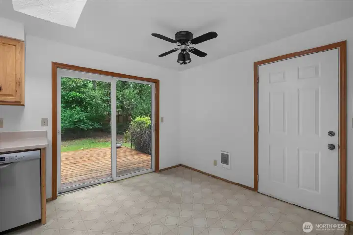 Bright kitchen and dining area with slider to the private backyard deck.