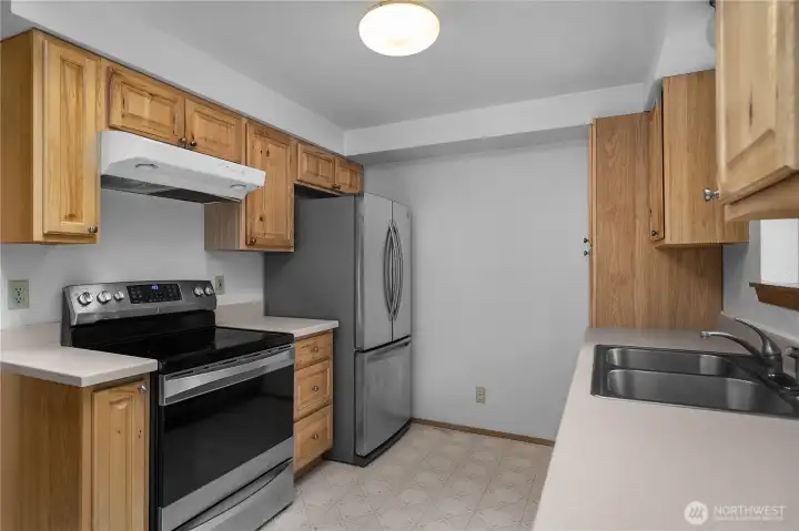 Bright & Updated kitchen with updated cabinets, good storage, and efficient workspace.
