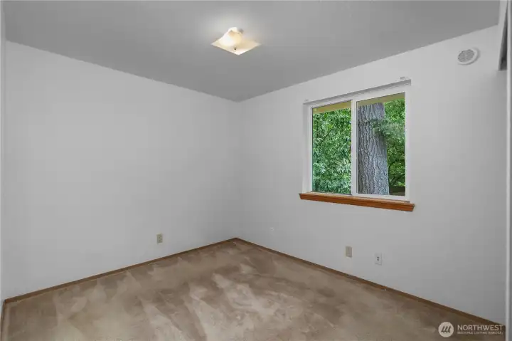BR 2 -bedroom with fresh interior paint, neutral finishes, and wooded outlook.