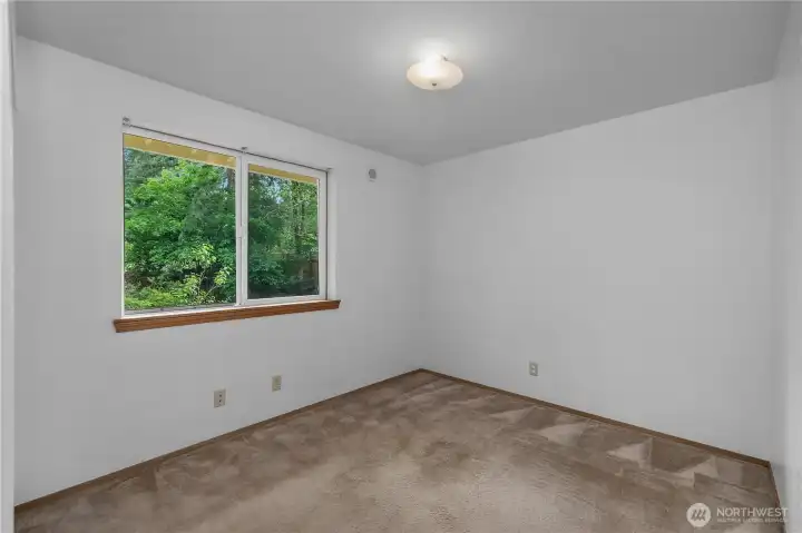 BR 2 - Comfortable bedroom with fresh paint, soft natural light, and peaceful backyard views.