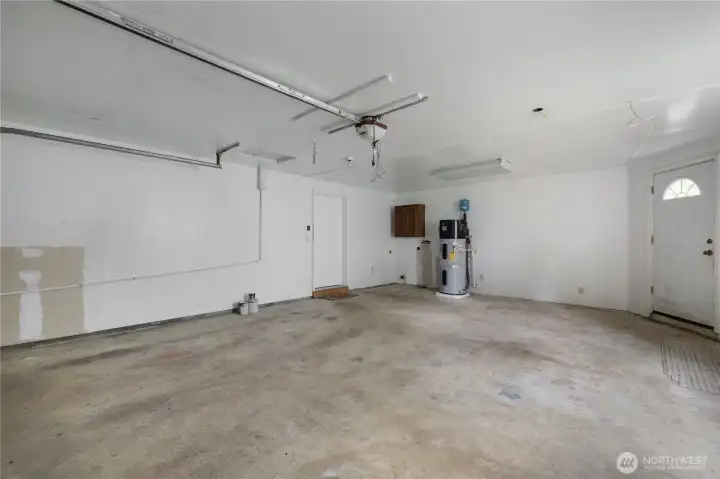 Oversized two-car garage with room for parking, storage, tools, and lake-life gear.