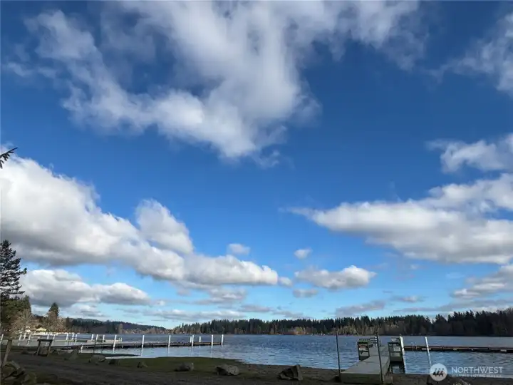 Beautiful Black Lake setting with beach access, dock, and wide-open sky for year-round enjoyment.