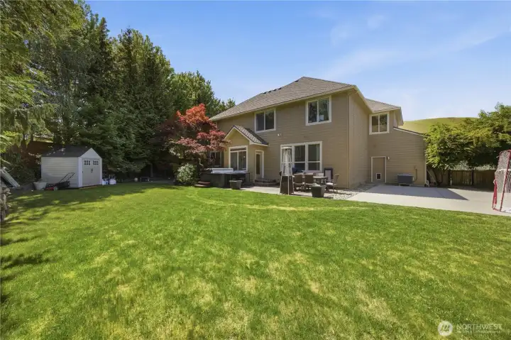 Private backyard retreat featuring outdoor living spaces, sports court access, and beautifully maintained grounds