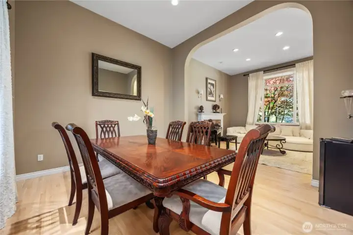 Formal dining room with elegant natural light, hardwood floors, and ideal entertaining space for gatherings and holidays.
