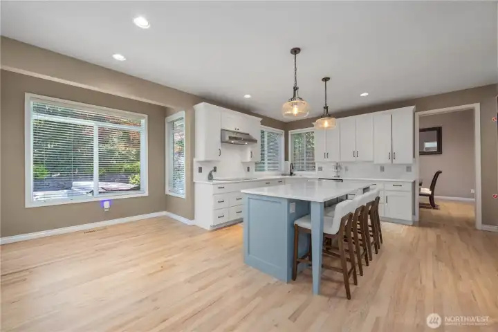 Gourmet kitchen with extensive cabinetry, new dishwasher, microwave, quartz counters, and functional workspace layout.