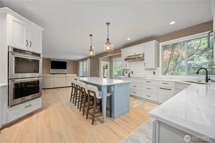 Gourmet kitchen with extensive cabinetry, new dishwasher, microwave, quartz counters, and functional workspace layout.
