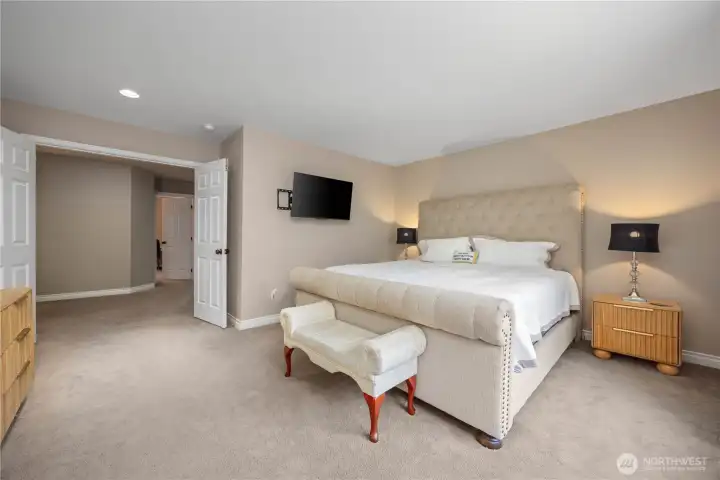 Spacious primary suite with blackout shades, large windows, and peaceful retreat-style layout.
