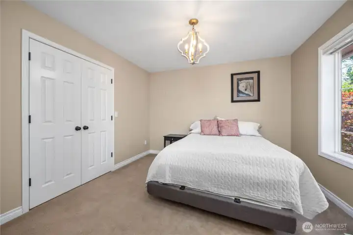 Spacious bedroom with walk-in closet, built-ins, and abundant natural light.