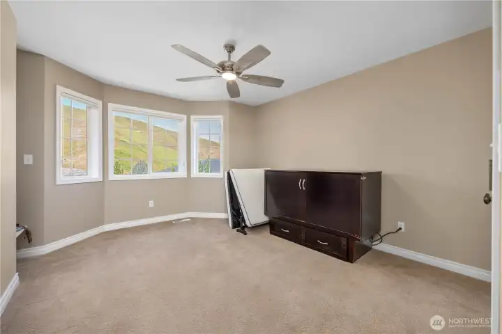 Secondary bedroom featuring organized closet storage, updated blinds, and flexible living space.