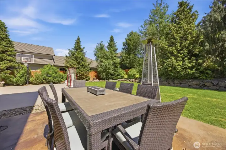 Backyard patio space perfect for BBQs, gatherings, and enjoying the beautifully maintained outdoor living area.