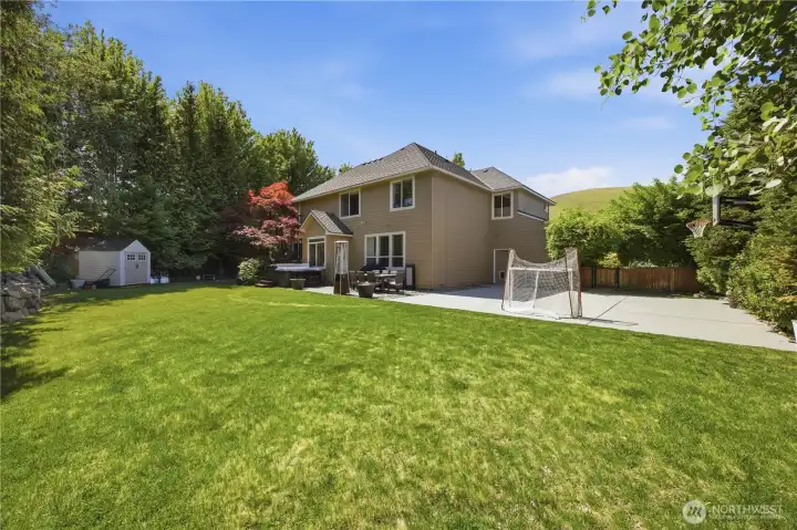 Spacious fully usable backyard with mature landscaping, entertaining areas, and room for recreation.