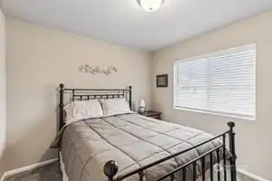 A sunny guest room w/plenty of closet storage space.