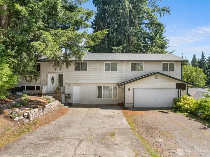 Split-level home featuring convenient RV parking and a separate lower-level entrance.
