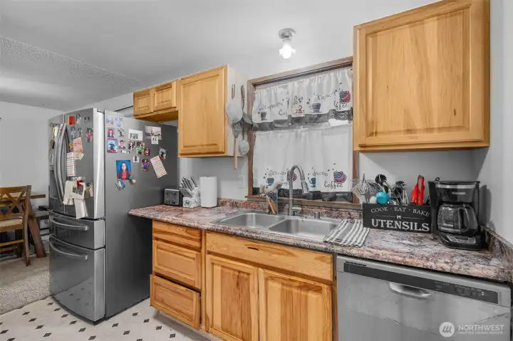 Kitchen with ample wood cabinet storage, stainless steel appliances