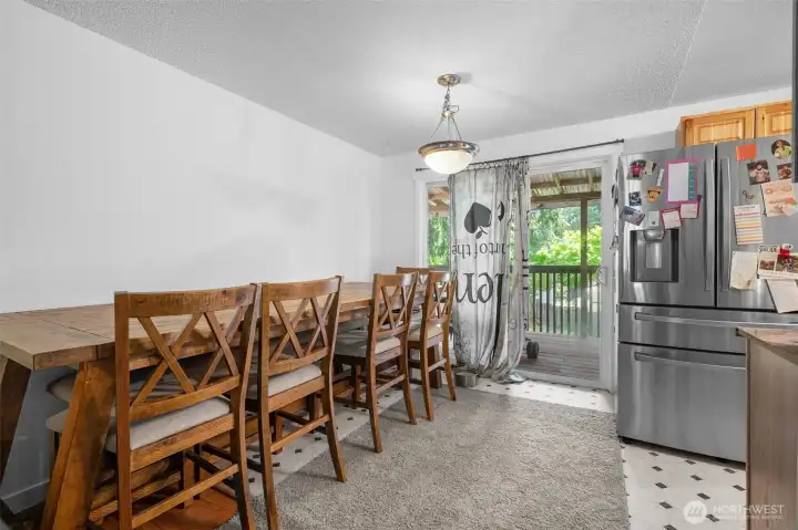 Inviting dining space conveniently located off the kitchen, complete with a large sliding door for ample natural light and deck access.
